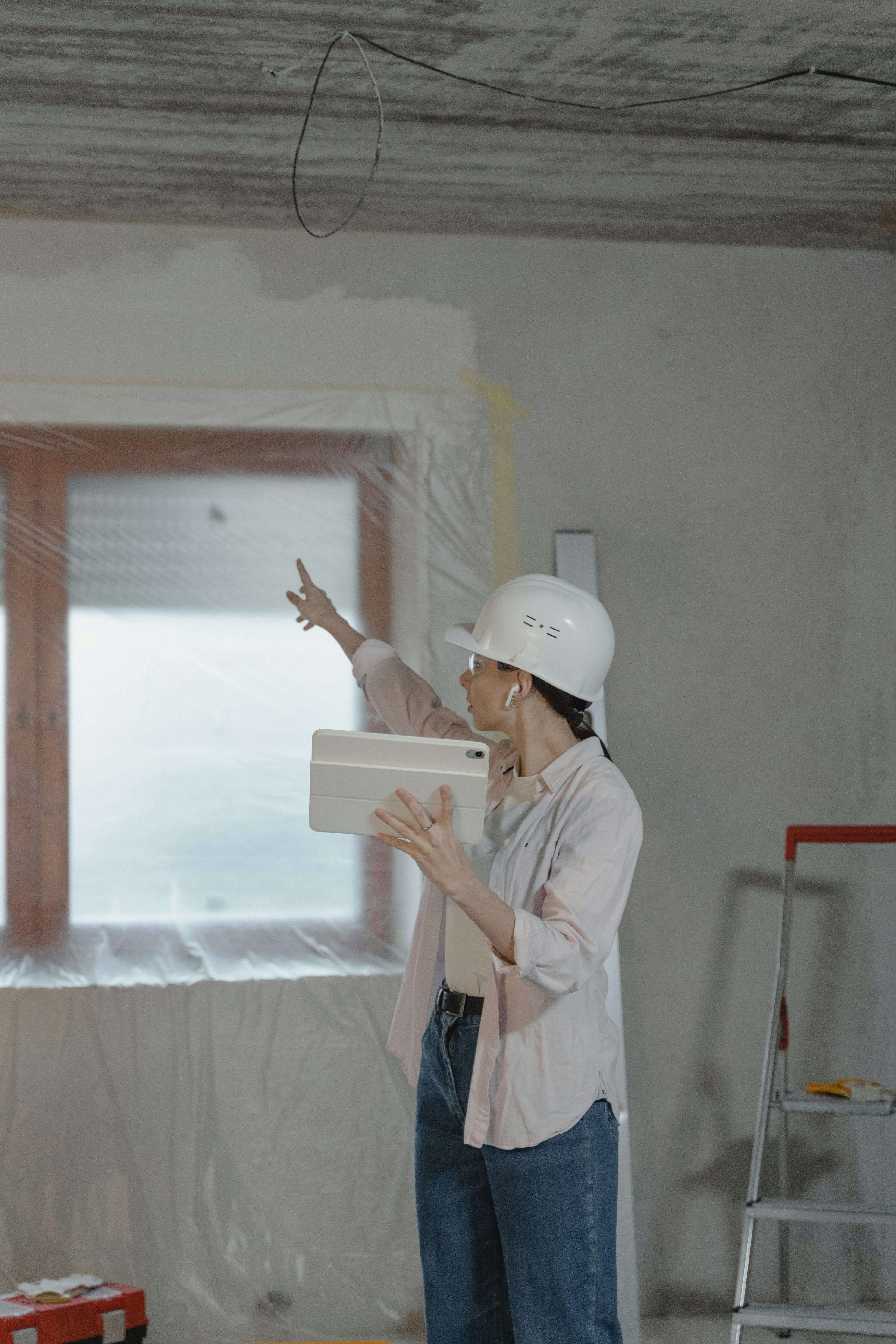 A construction manager walking a site with a tablet, identifying punch-list items
